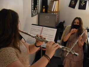 teaching flute student in office